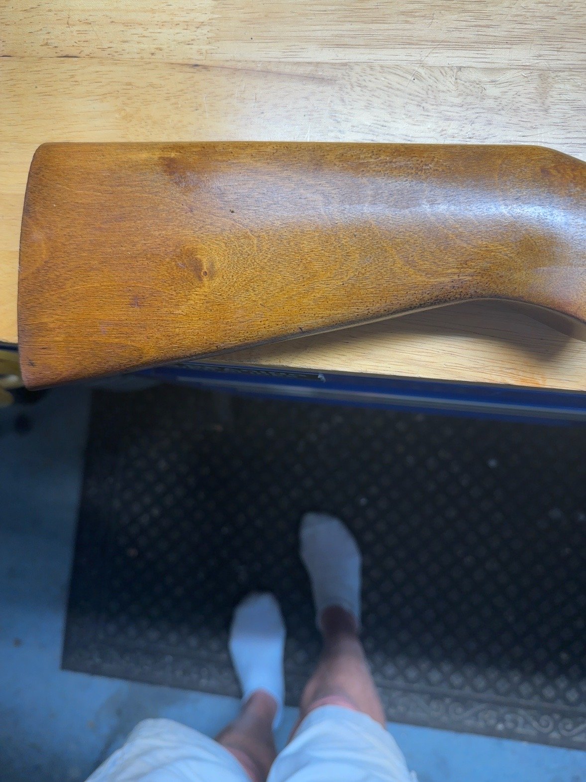 Close-up of wooden stock showing wear and finish
