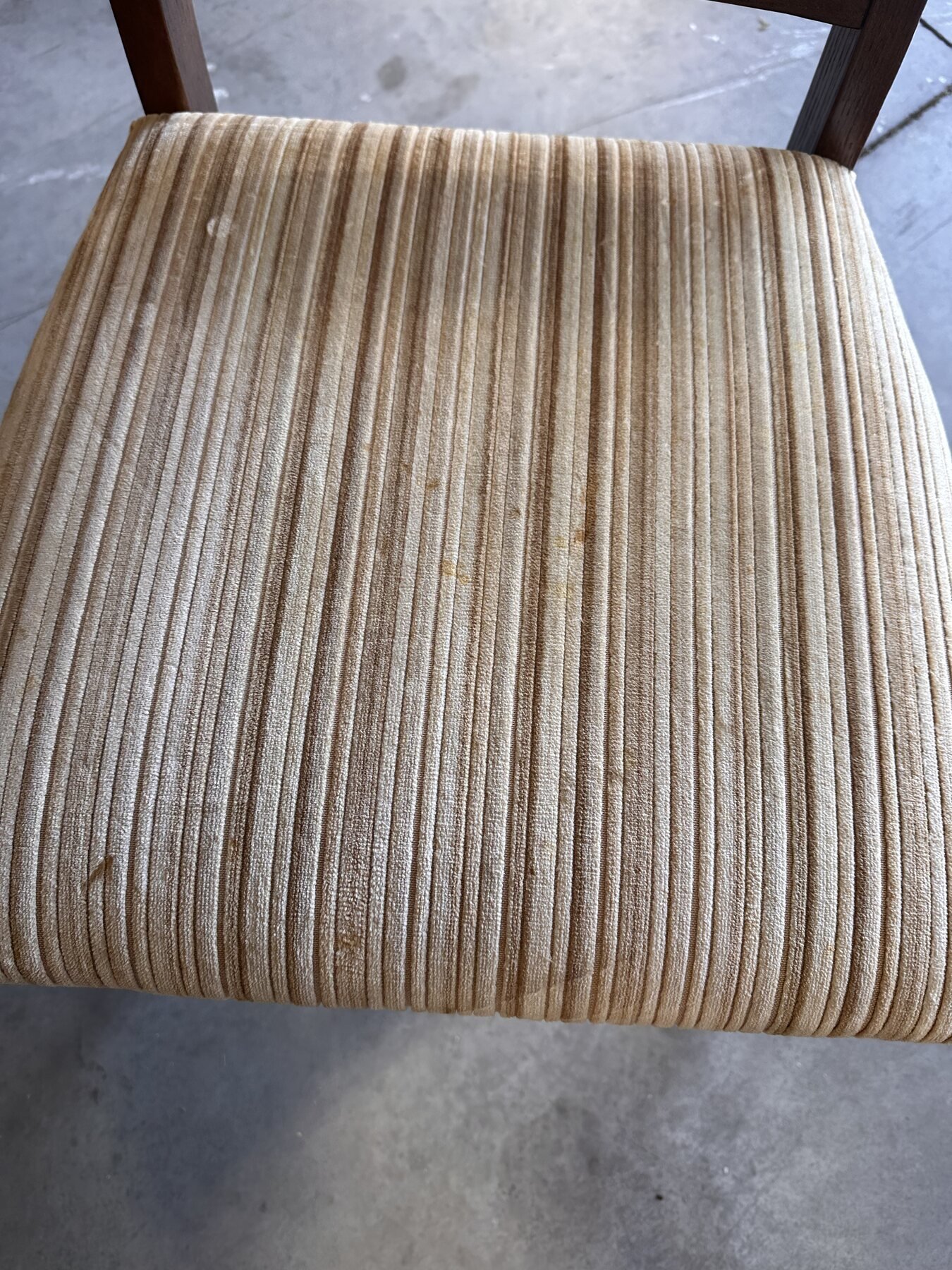 Close view of the first chair's striped upholstered seat