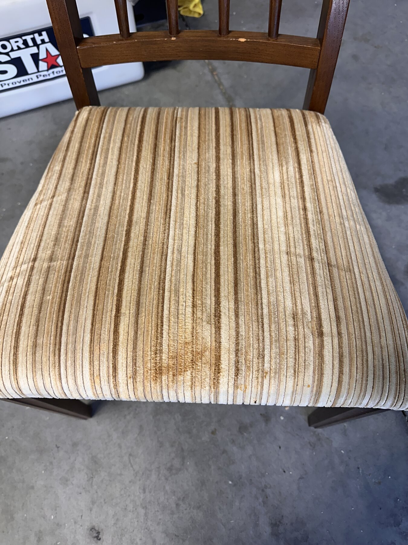 Second chair with a visibly stained striped upholstered seat