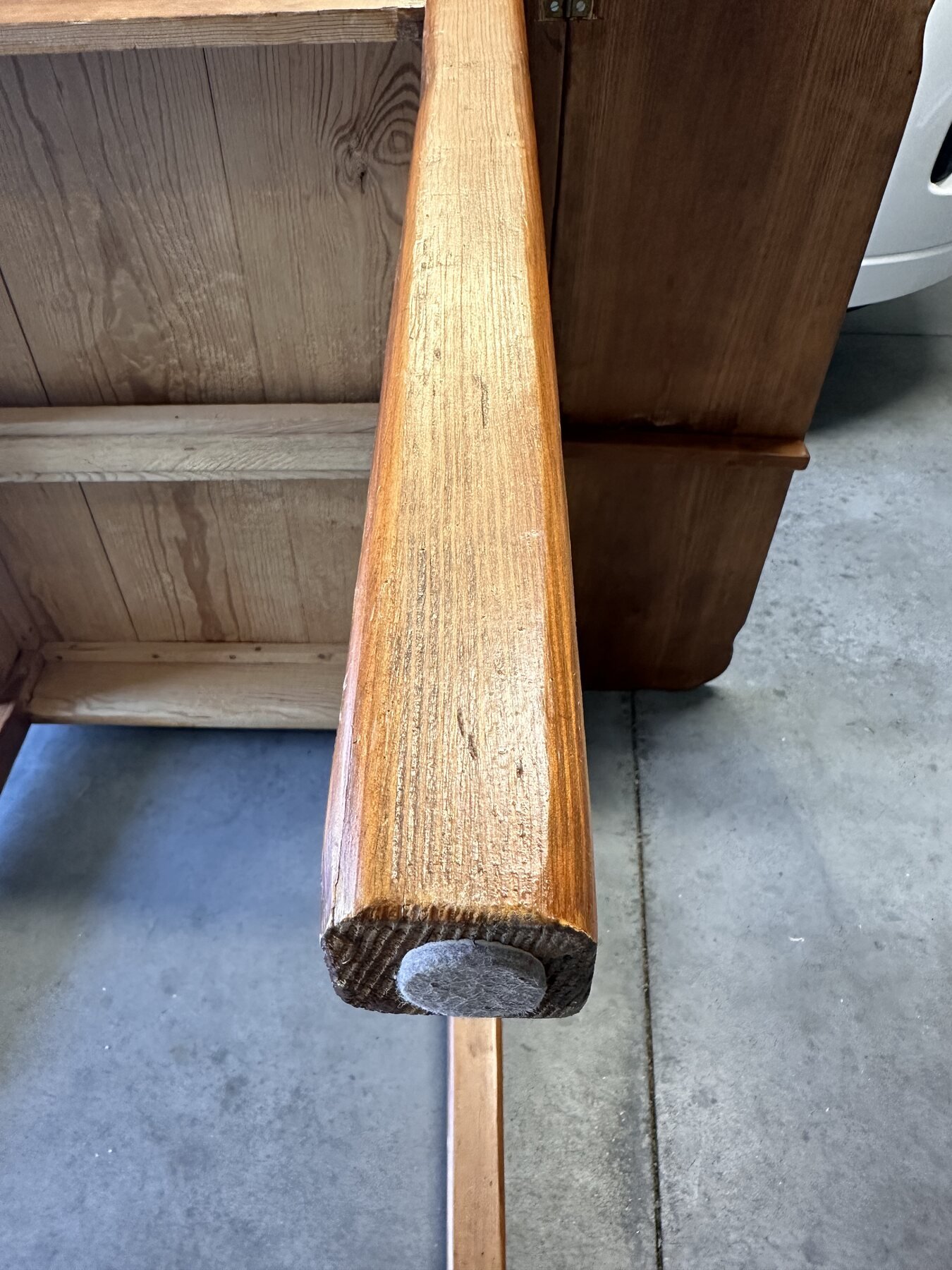 End grain and felt pad on the first wooden drop-leaf support