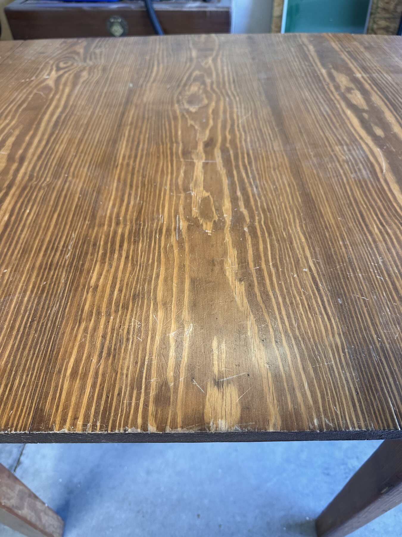 Low-angle view across the scratched and worn tabletop