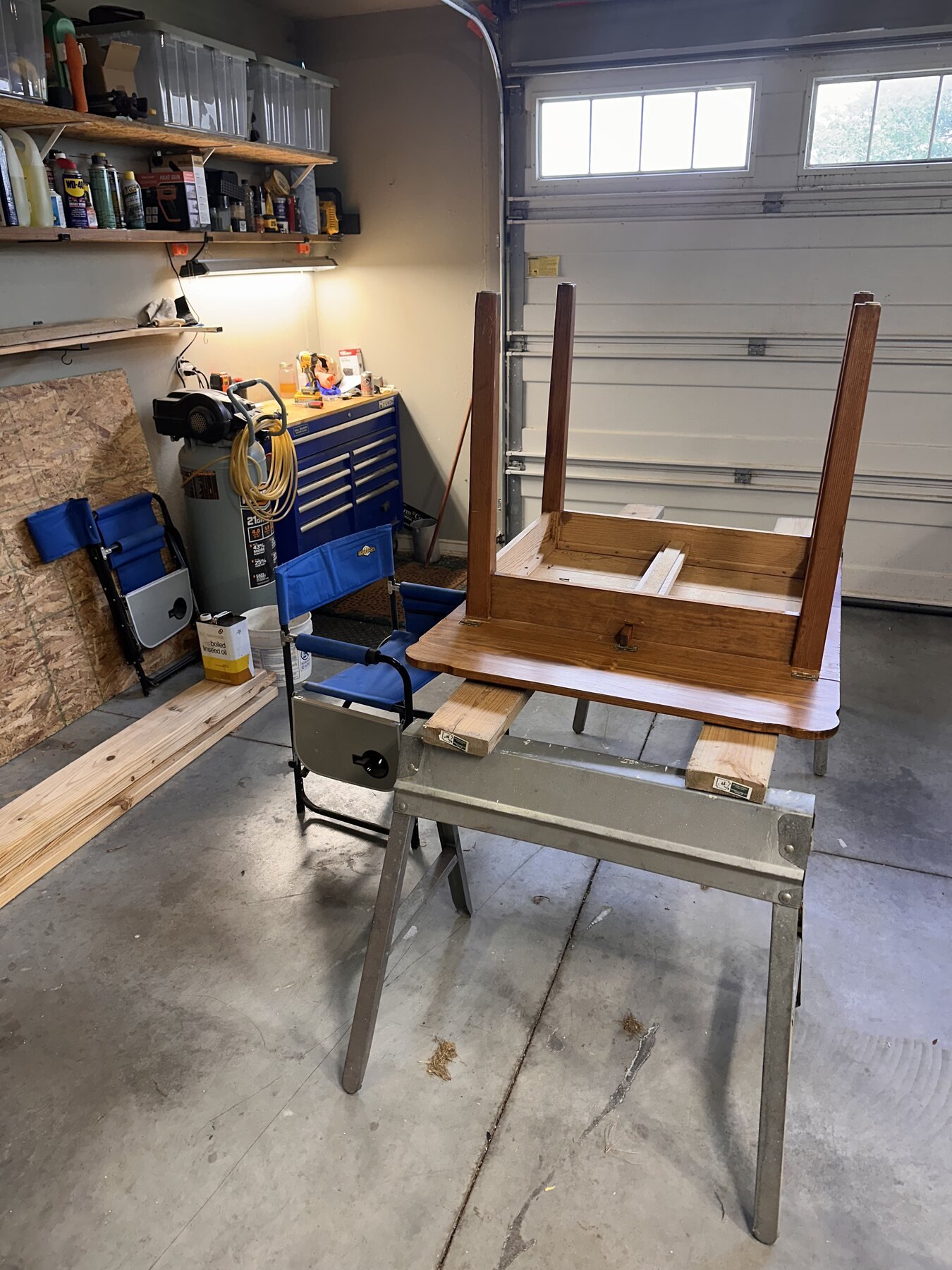 Second wide view of the table base still attached to the upside-down tabletop