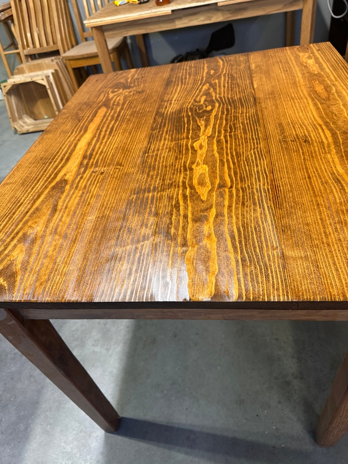 Lengthwise view of the coated tabletop with a bright reflection near the front edge