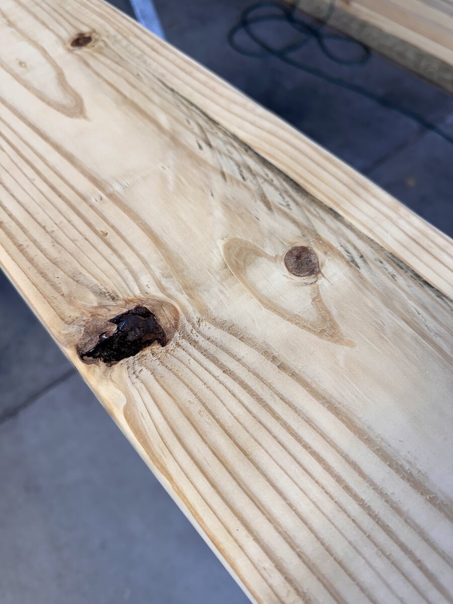 Dark dramatic knot in the pine board