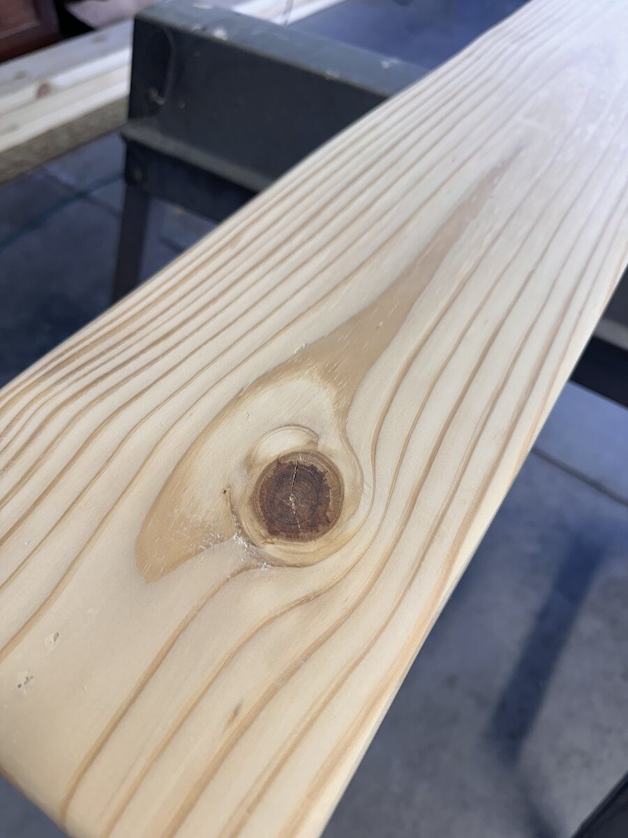Small quiet knot in straight pine grain