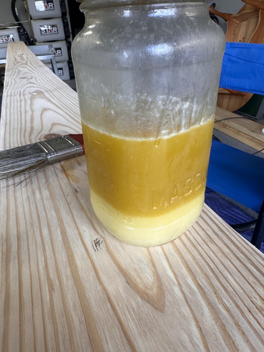 Separated layers visible inside the jar of wood finish