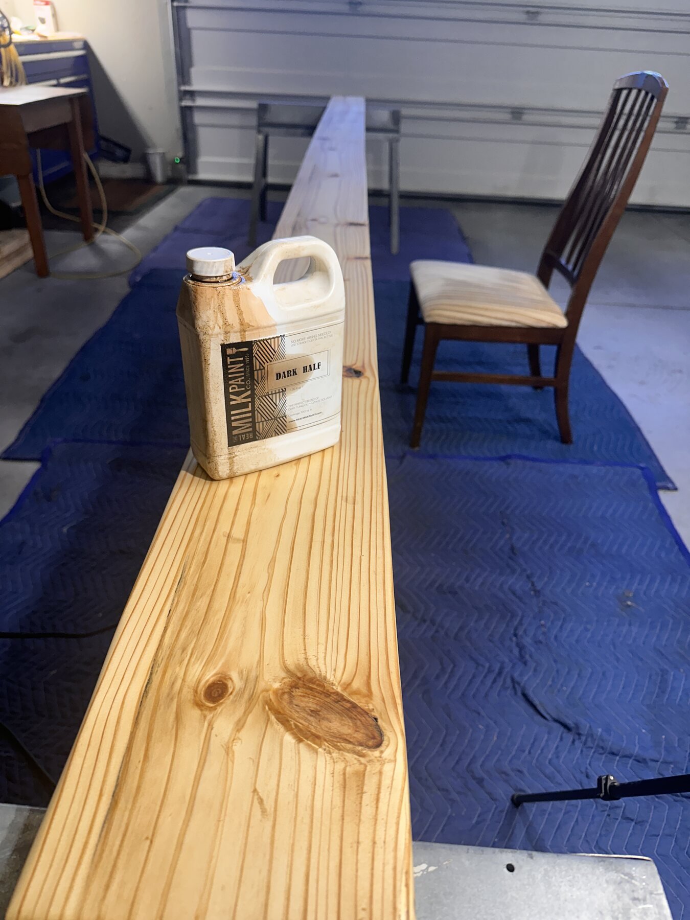 Long pine board with Dark Half bottle sitting on top