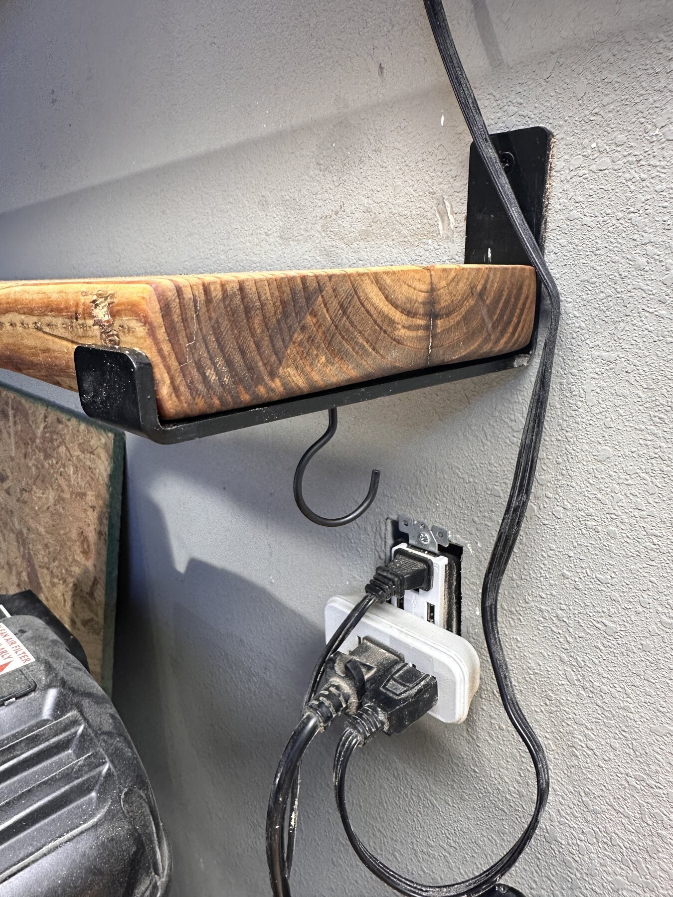Finished shelf end seated tightly against the bracket and wall