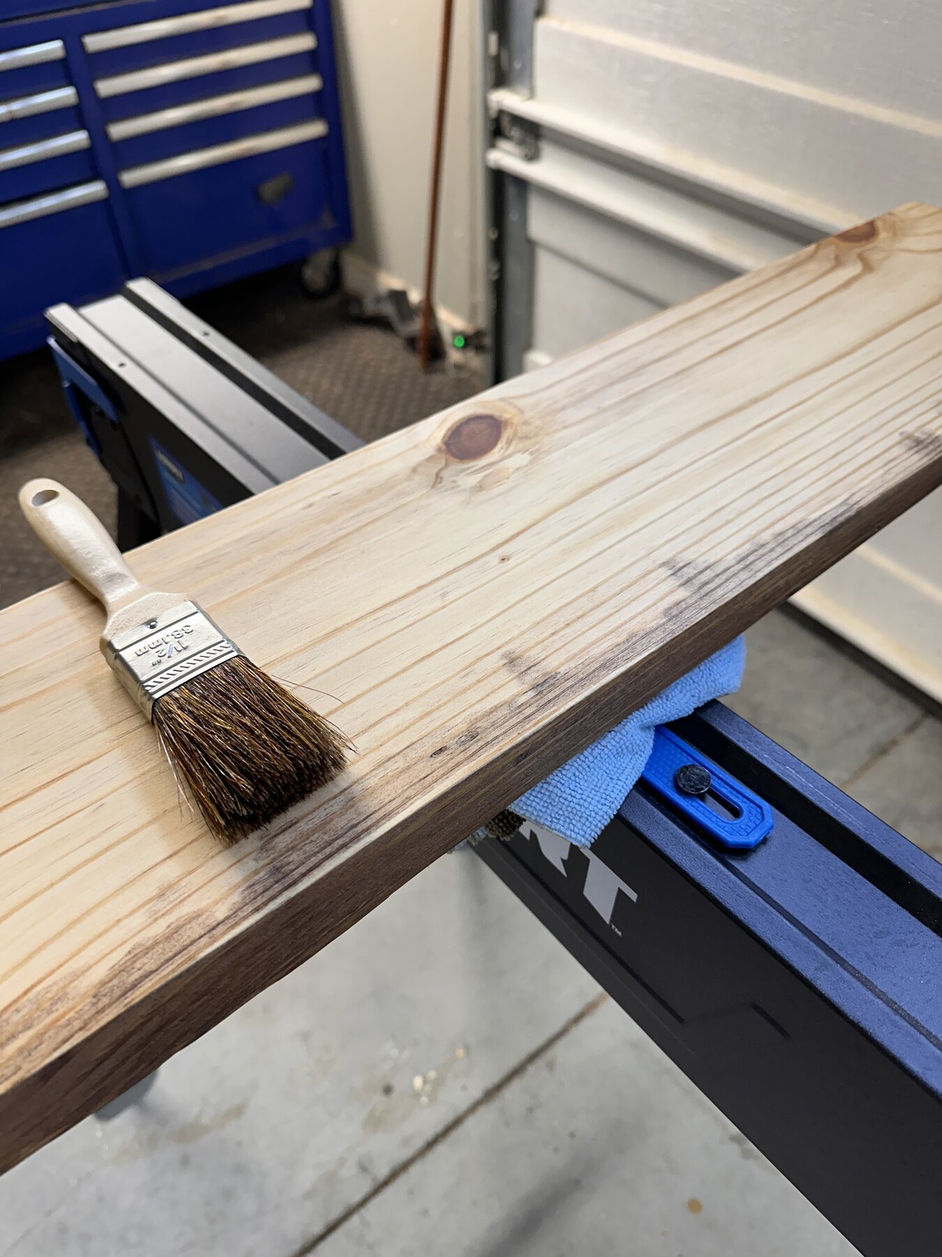 Brush resting beside the first pass of Early American stain on Board Two