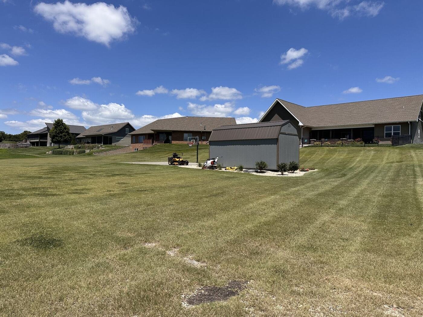 Wide view of the landscaped shed and surrounding lawn on July 9