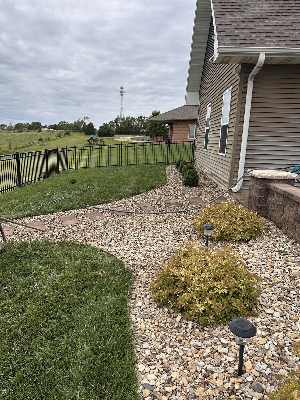 New rock path with steppingstones and plantings beside the house