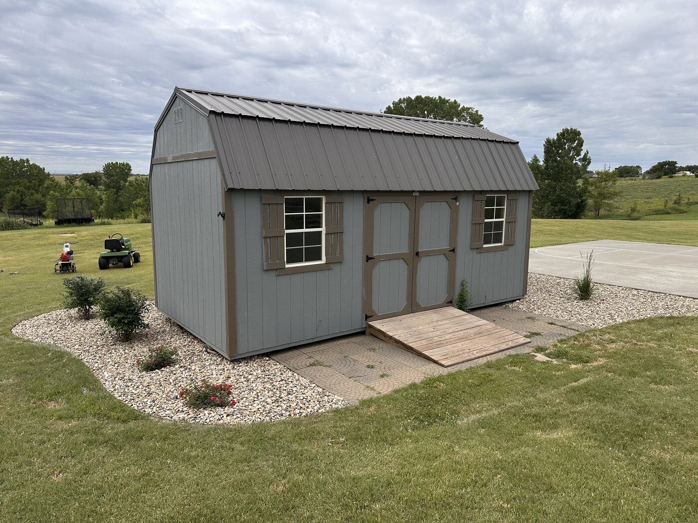 Wide view of the completed shed landscaping on June 18, 2026