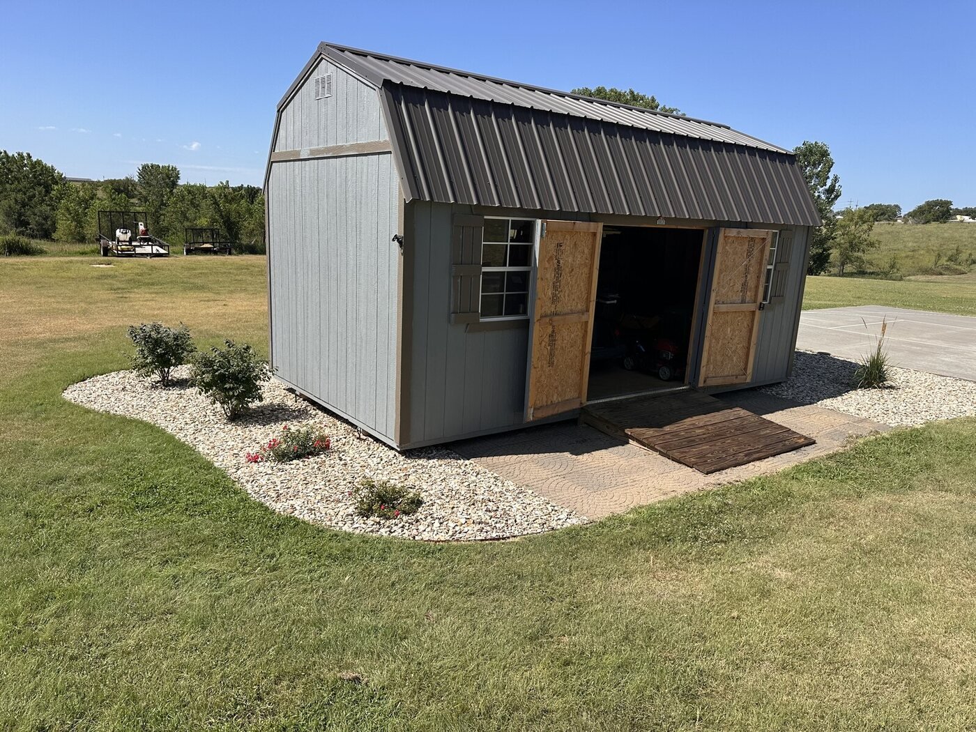 Picture Day overview of the shed entrance, roses, and shrubs