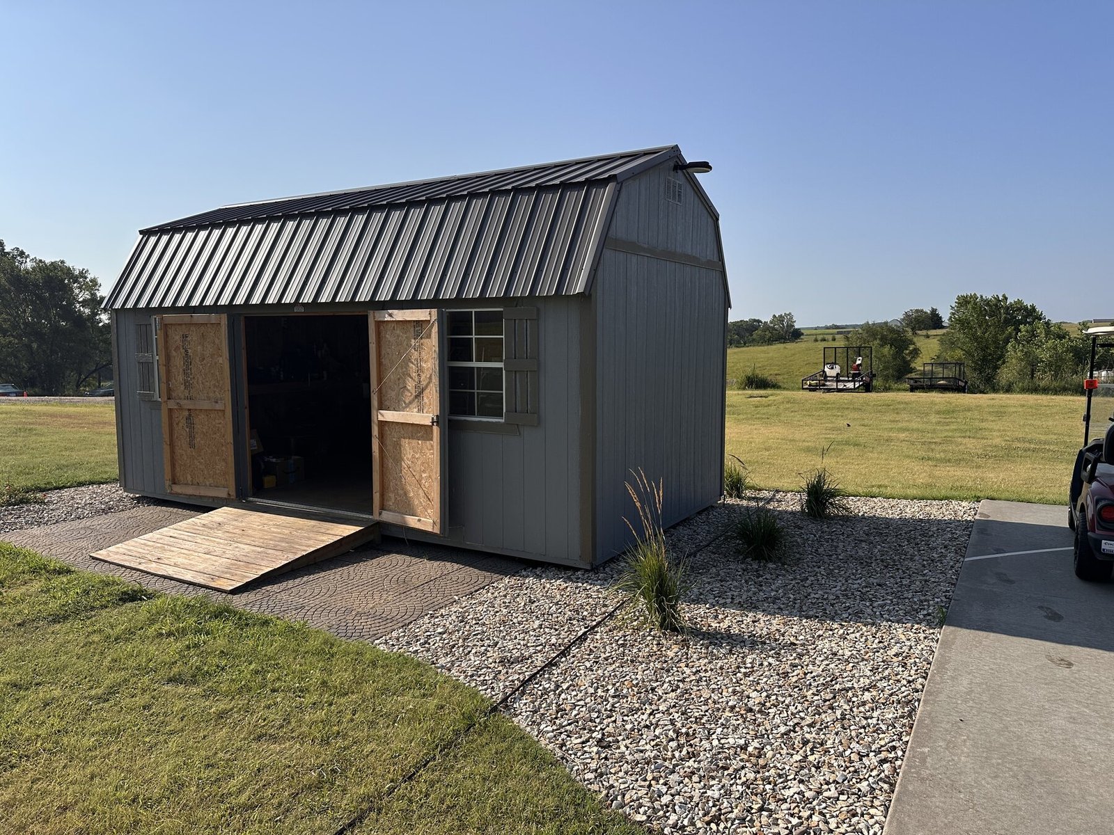 Shed front with open doors and darkened ramp after linseed oil