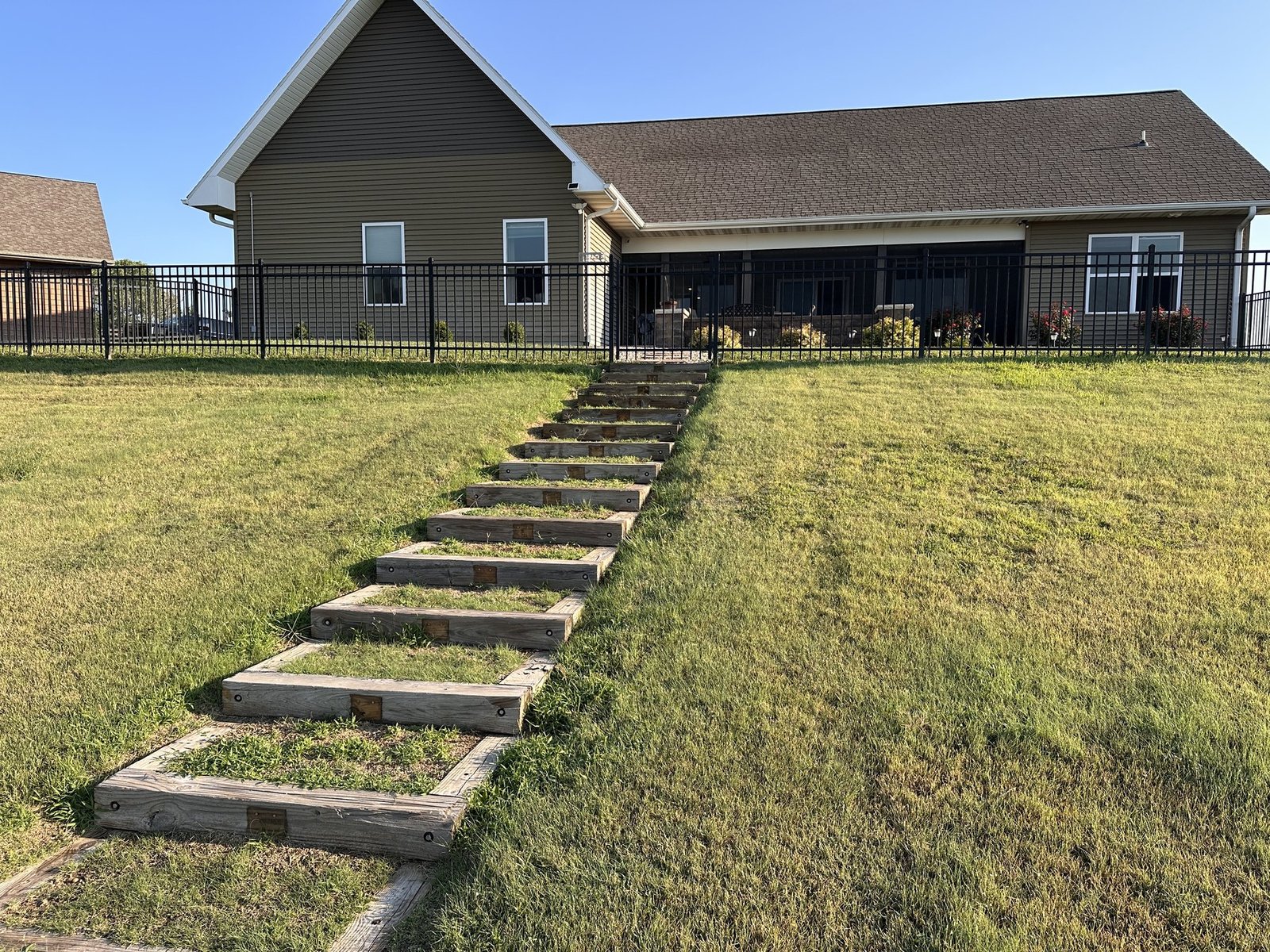 Steppingstone path crossing the lawn from the shed toward the back of the house
